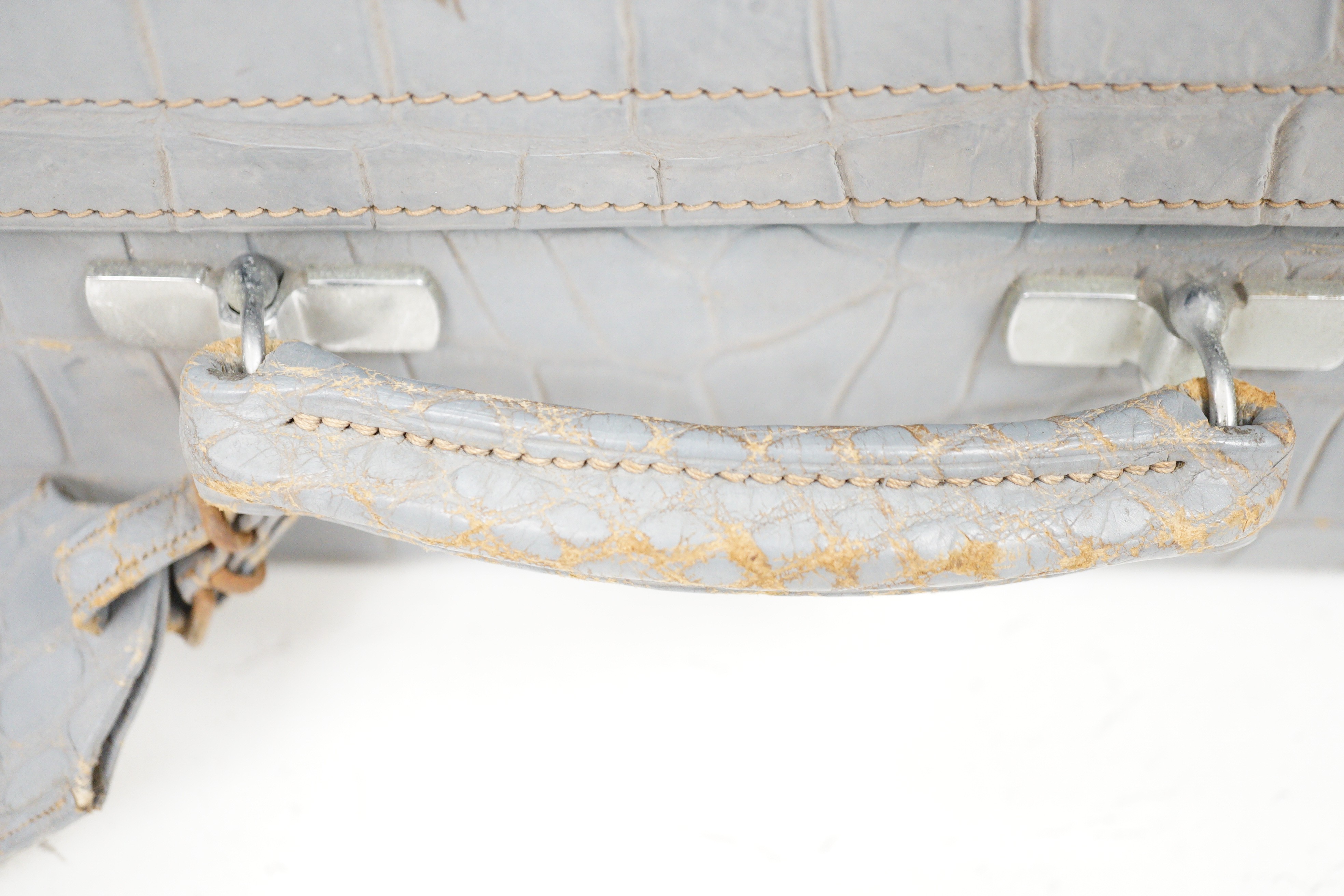 A pair of blue/grey faux crocodile suitcases